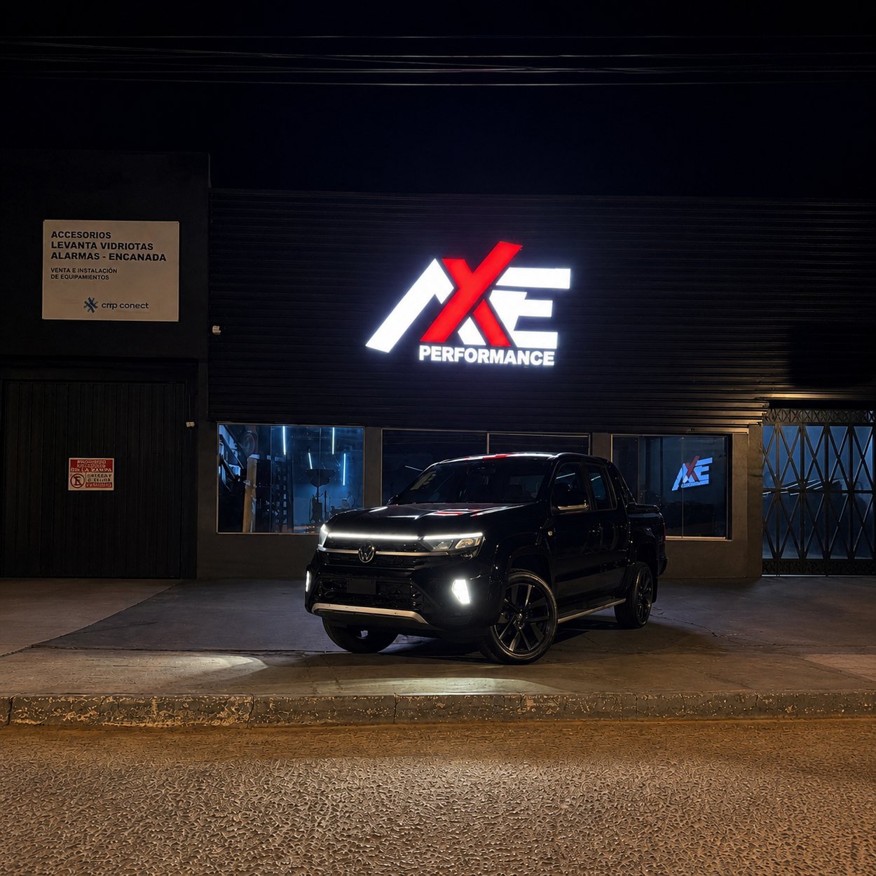 Volkswagen Amarok preta em frente à fachada da AXE Performance